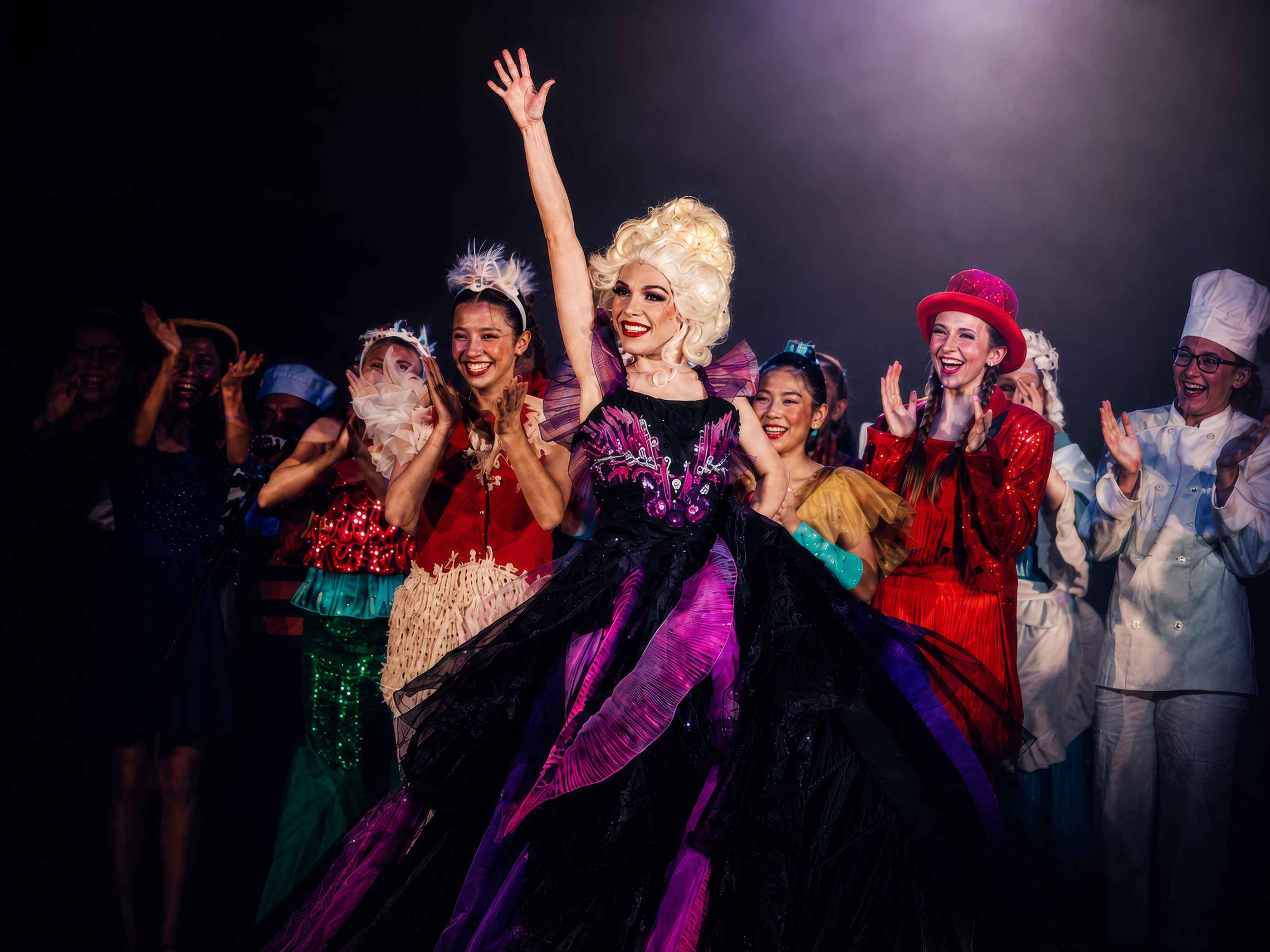 Young performers celebrating on stage at Revolution Theatre Company