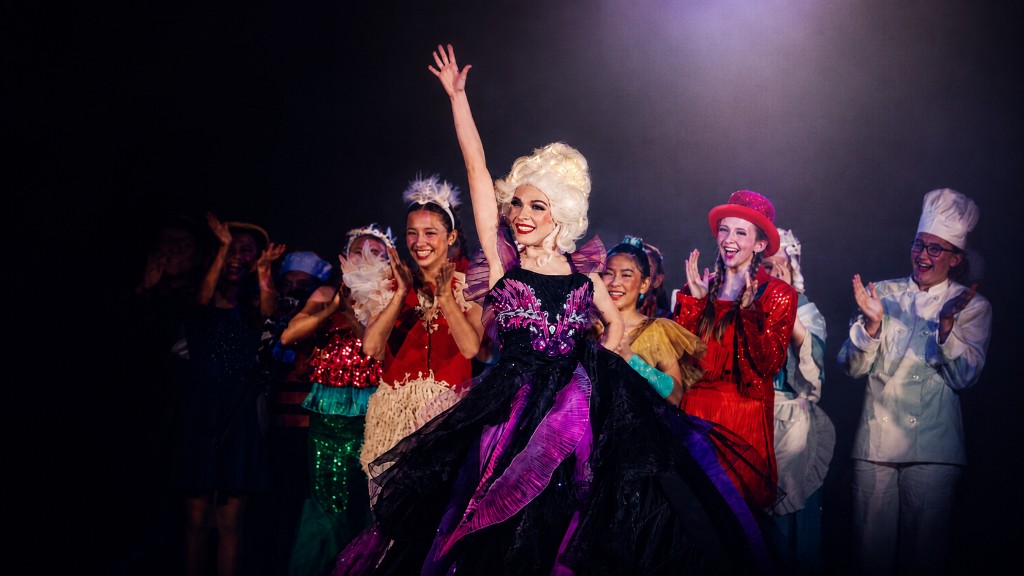Young performers celebrating on stage at Revolution Theatre Company